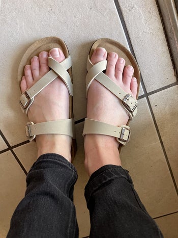 a pair of reviewer's feet wearing the sandals 