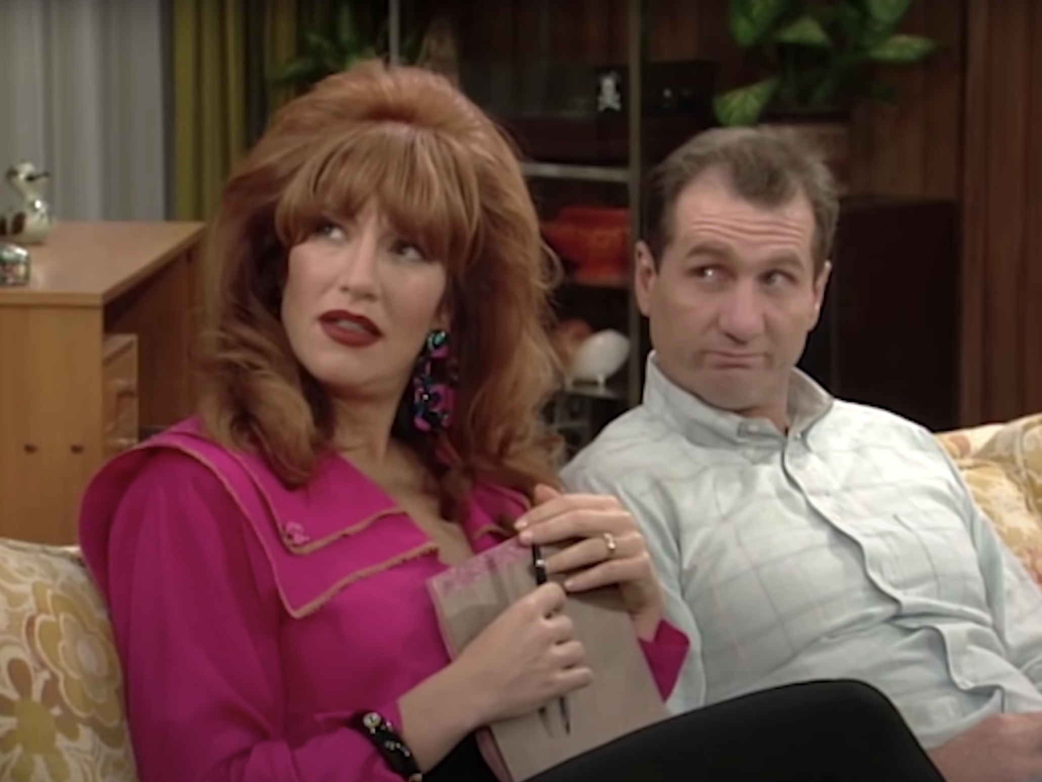 Al Bundy and Peggy sitting on the couch. 