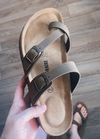 a reviewer holding the sandal 