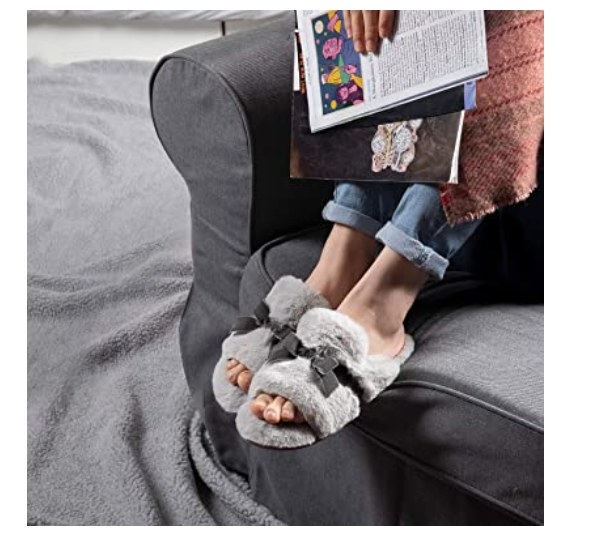 Foto de persona utilizando unas pantuflas con diseño de sandalias en color gris