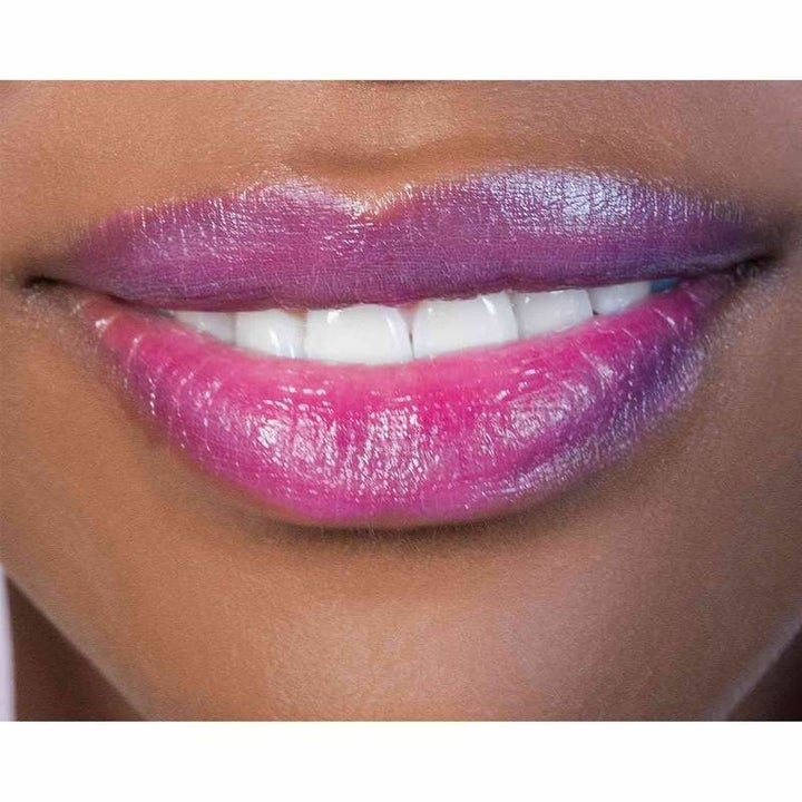 the bright pink-purple shade on a pair of lips