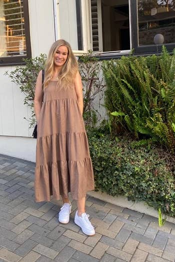 a reviewer wearing the dress in tan