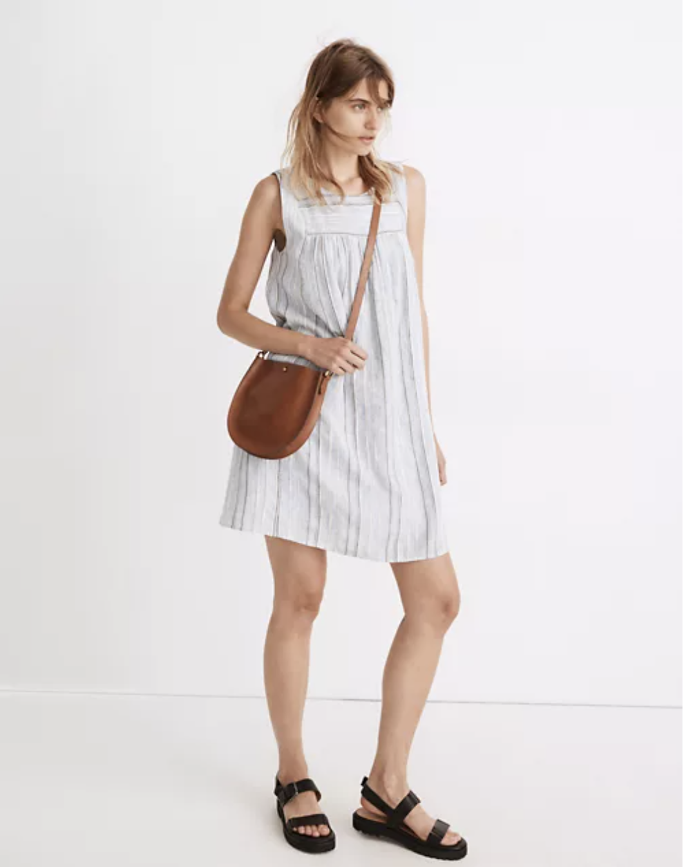 Model in a blue and white striped dress with a square cut collar