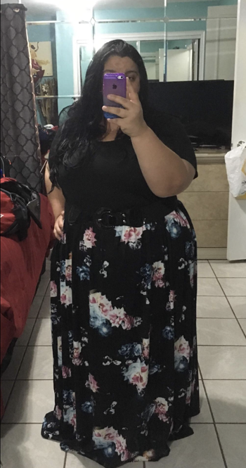 reviewer in a version with a black top and floral white and black bottom