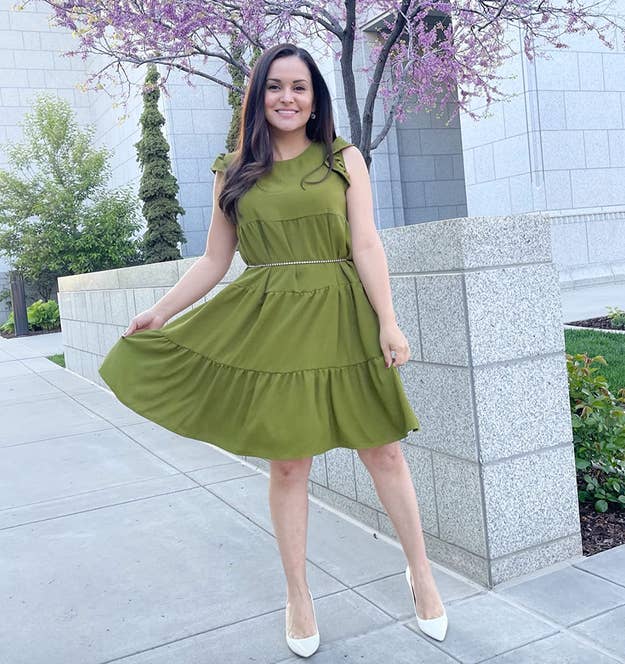 reviewer wearing green tiered midi dress with ruffled sleeves