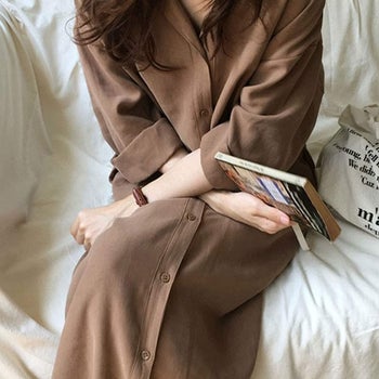 a reviewer wearing the collared dress in brown