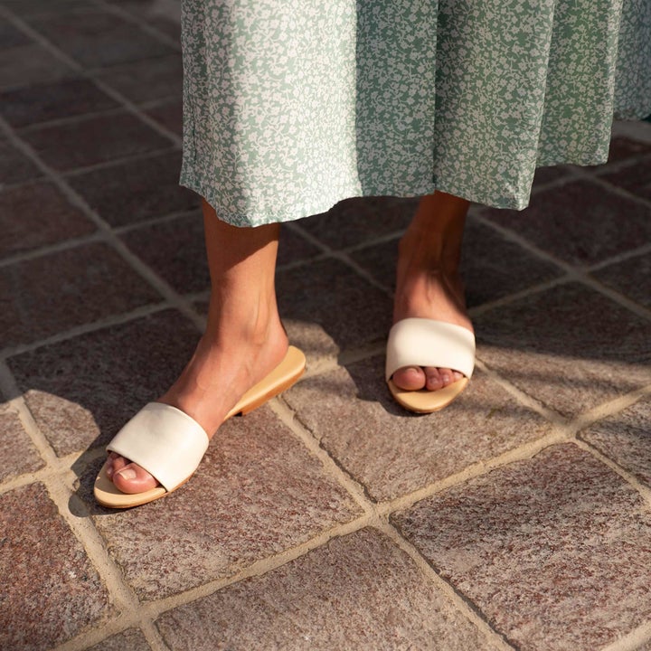model's feet with the white slides