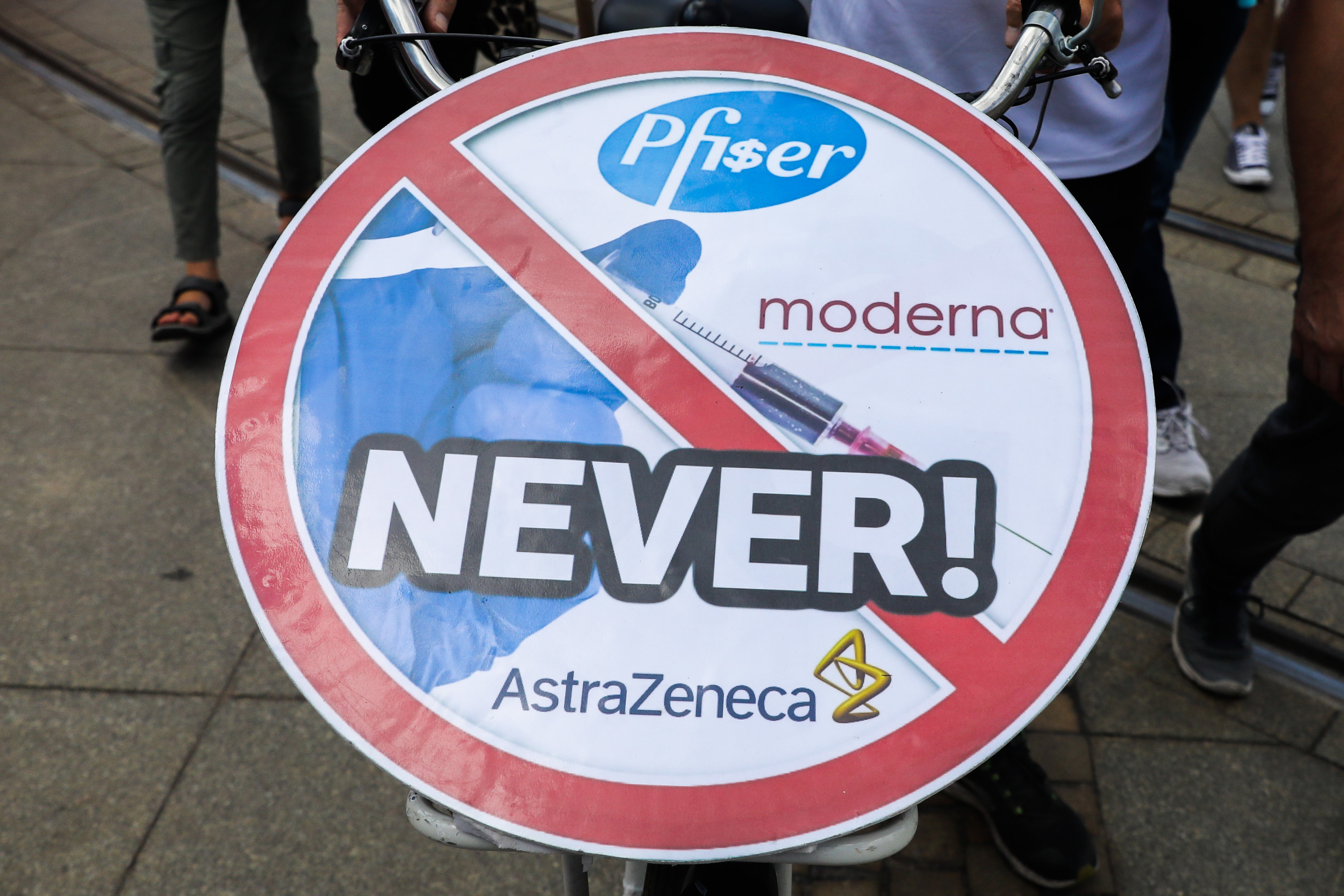 Anti-vaccine sign with &quot;NEVER&quot; written across the logos of vaccine manufacturers