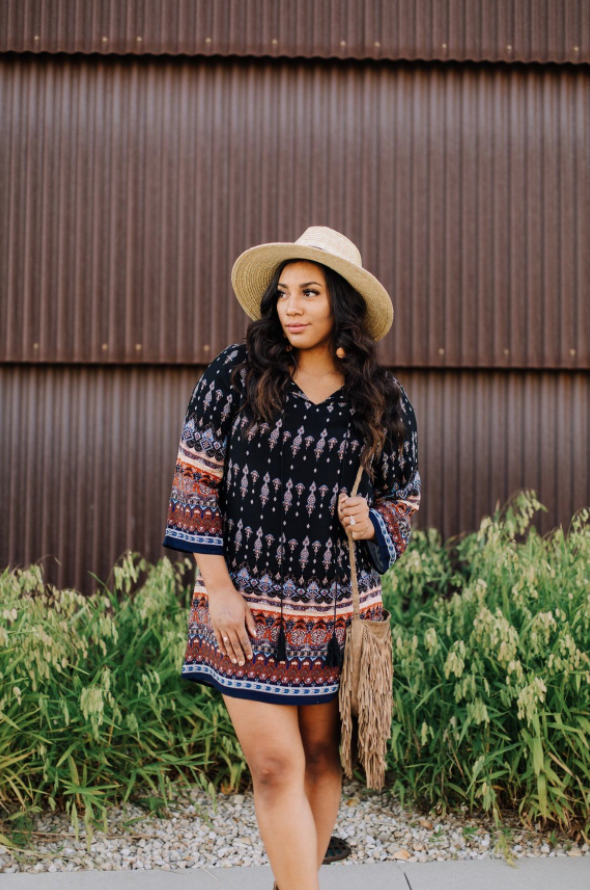reviewer wearing long-sleeve midi in a boho-style print with bag and hat