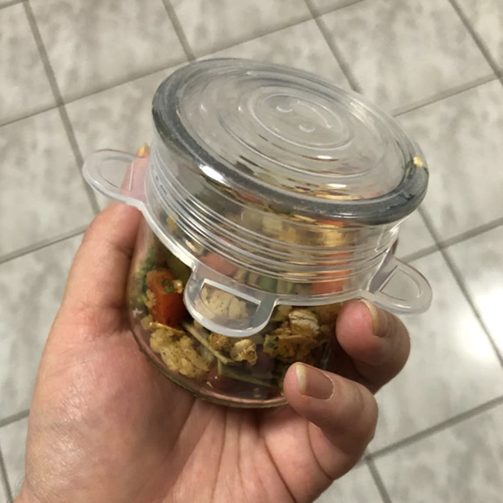 Reviewer image of small cup with food and silicone stretch lid covering it 