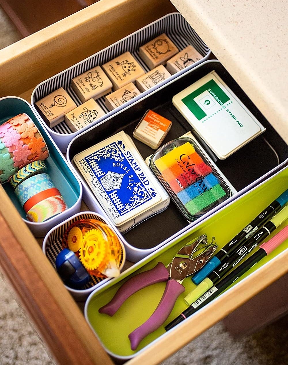 An open drawer with interlocking organizers inside