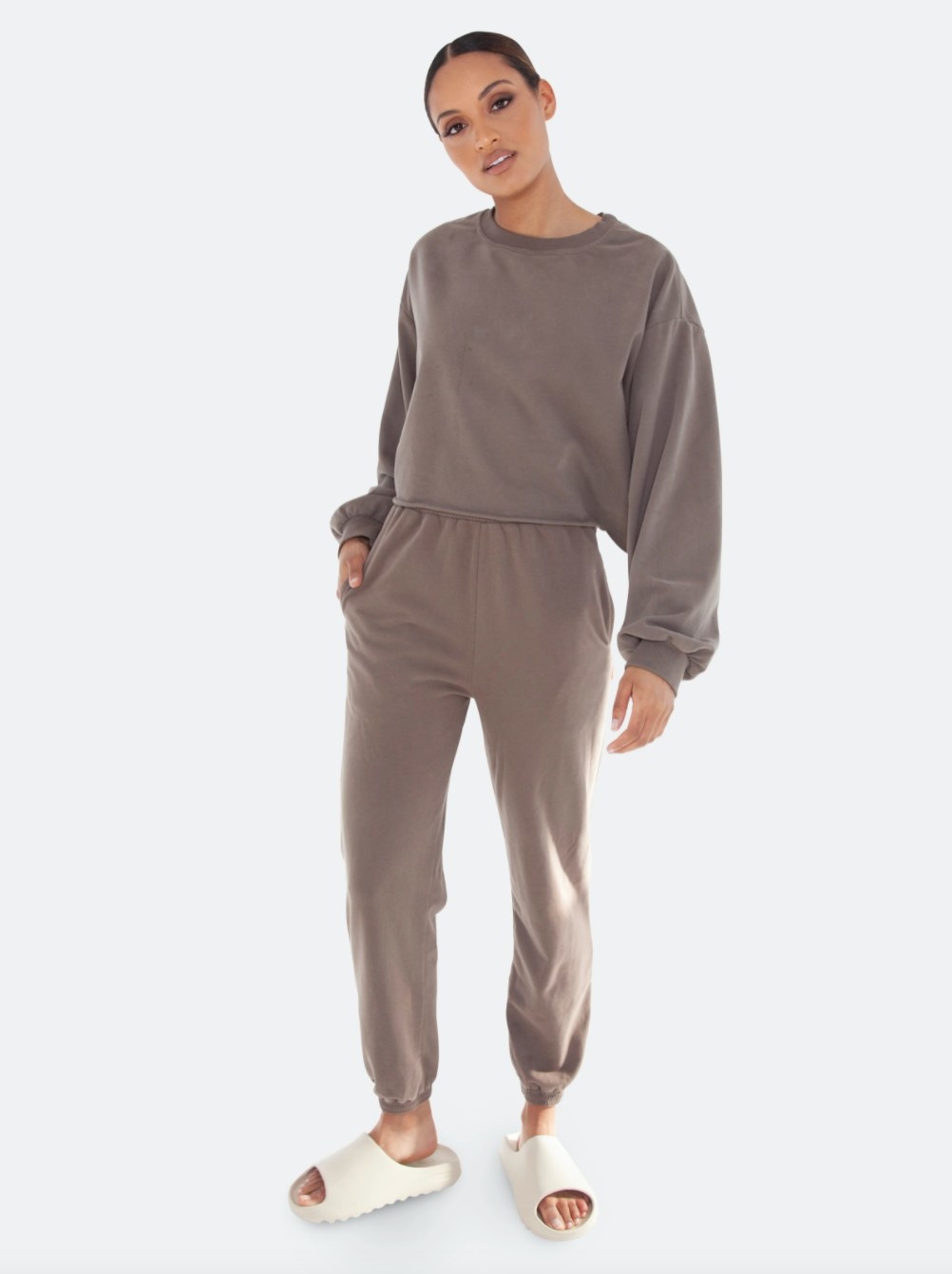 the high waisted sweats in brown on a model