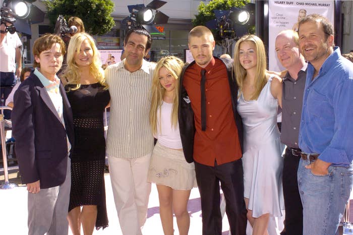 Chad posing with several people during a red carpet premiere