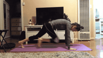 gif of a person doing mountain climbers on a yoga mat in front of their TV