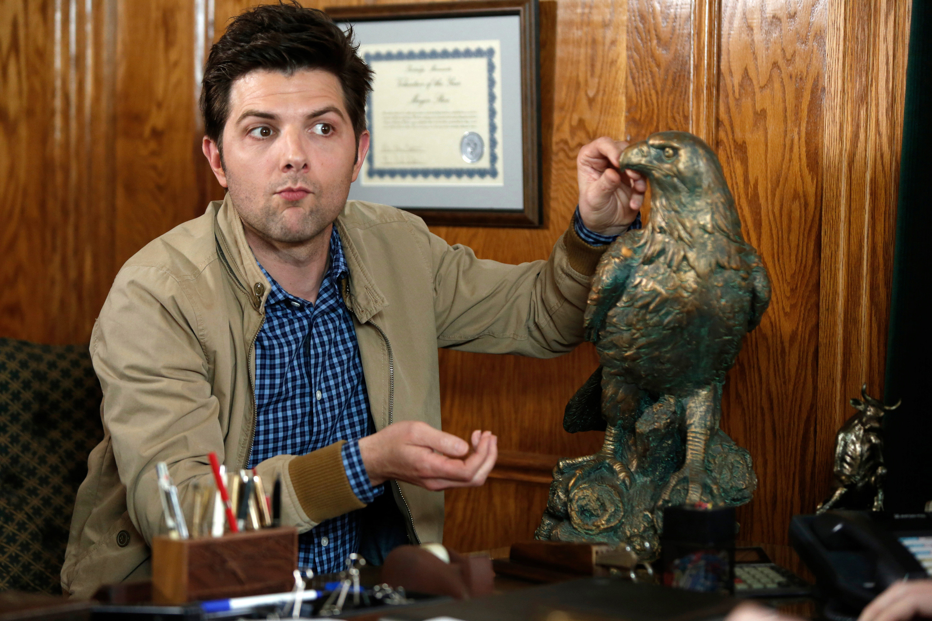 Ben Wyatt sitting at a desk on &quot;Parks and Rec&quot;