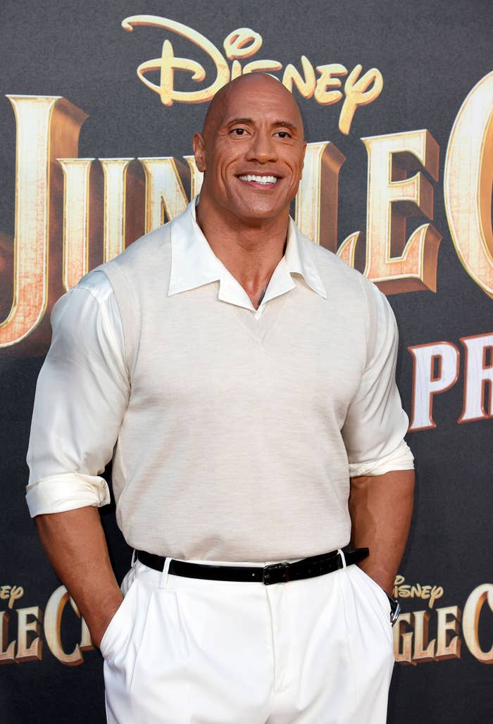 Dwayne Johnson smiling with hands in pockets