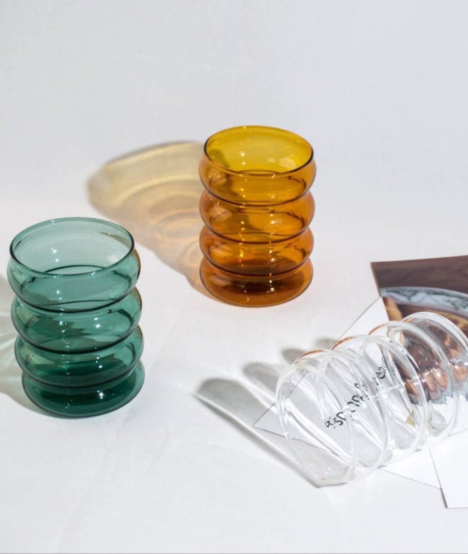 three glasses in different colors. all have a stacked ripple effect.