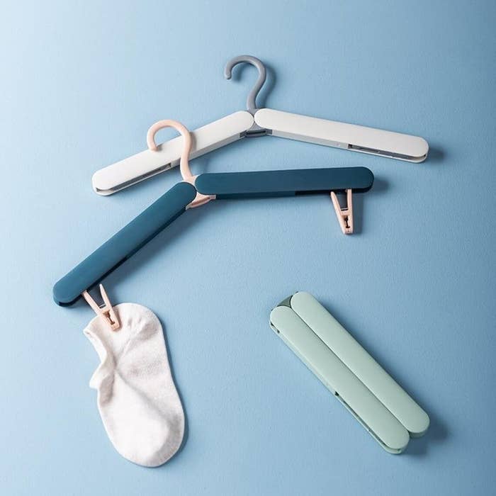 A trio of folding hangers with clips on a colourful background