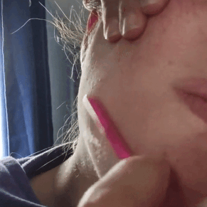 a gif of a reviewer using the razor on their face 