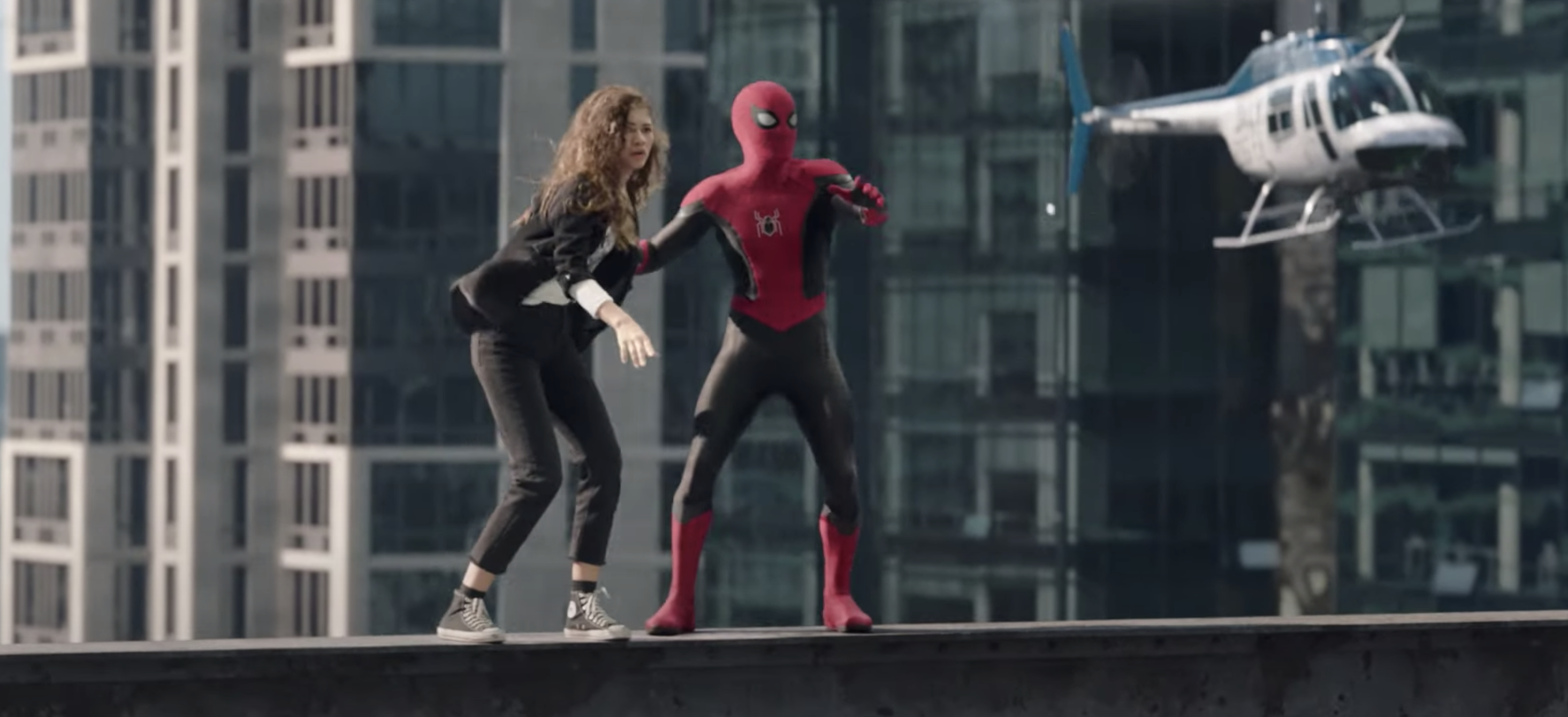 MJ and Spider-Man standing on a building