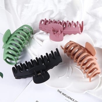 Claw clips in green, black, beige, and pink 