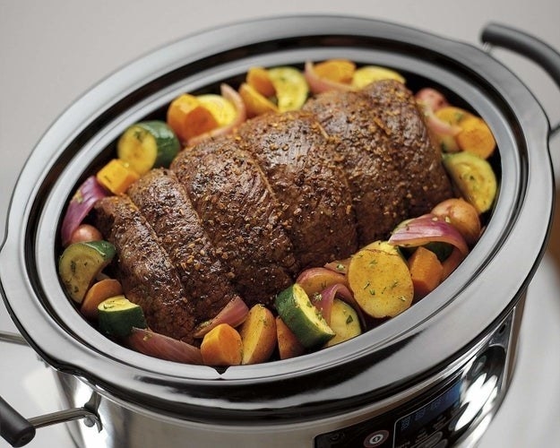 large slow cooker cooking up meat and veggies