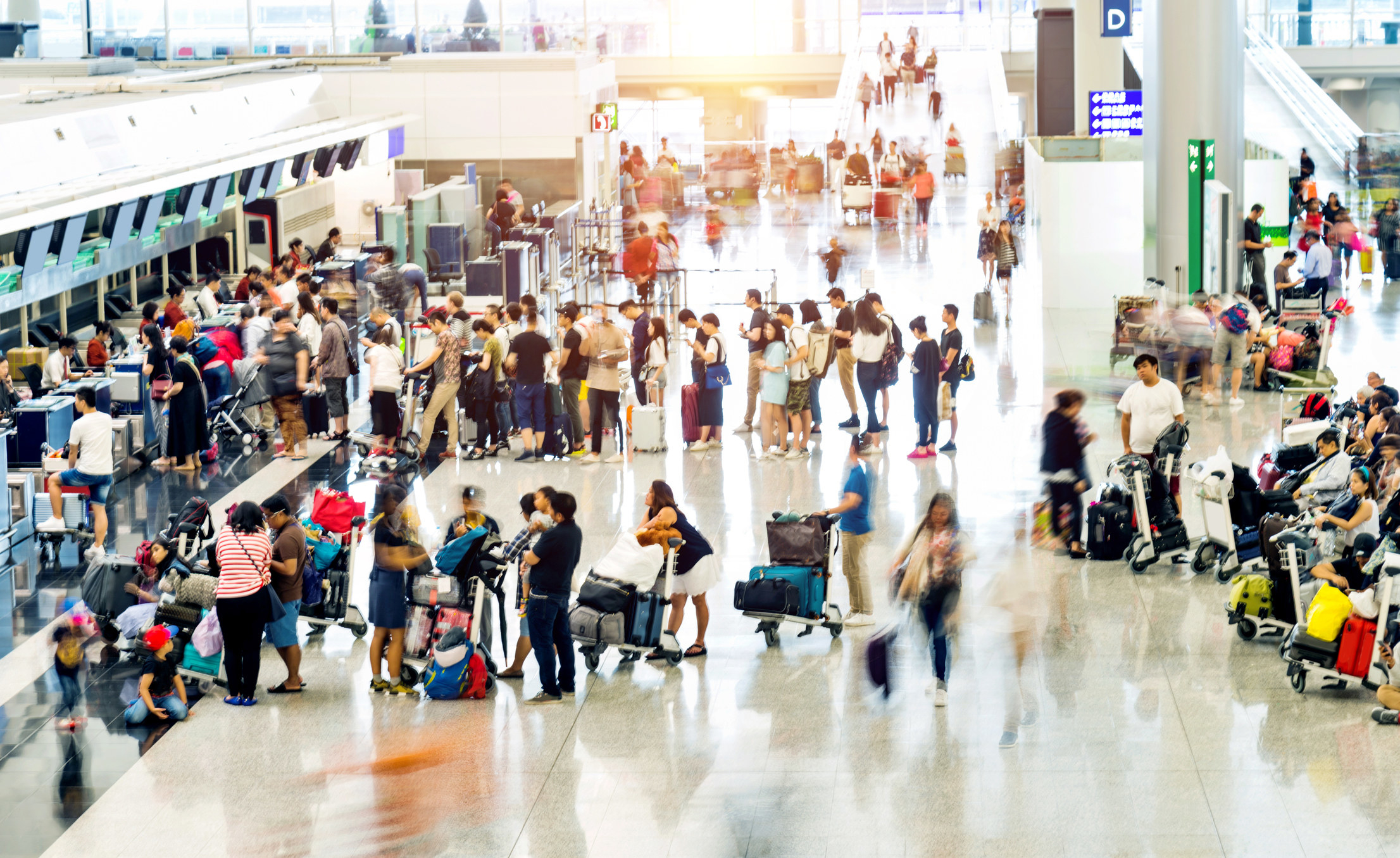 A crowded check-in area at an airport