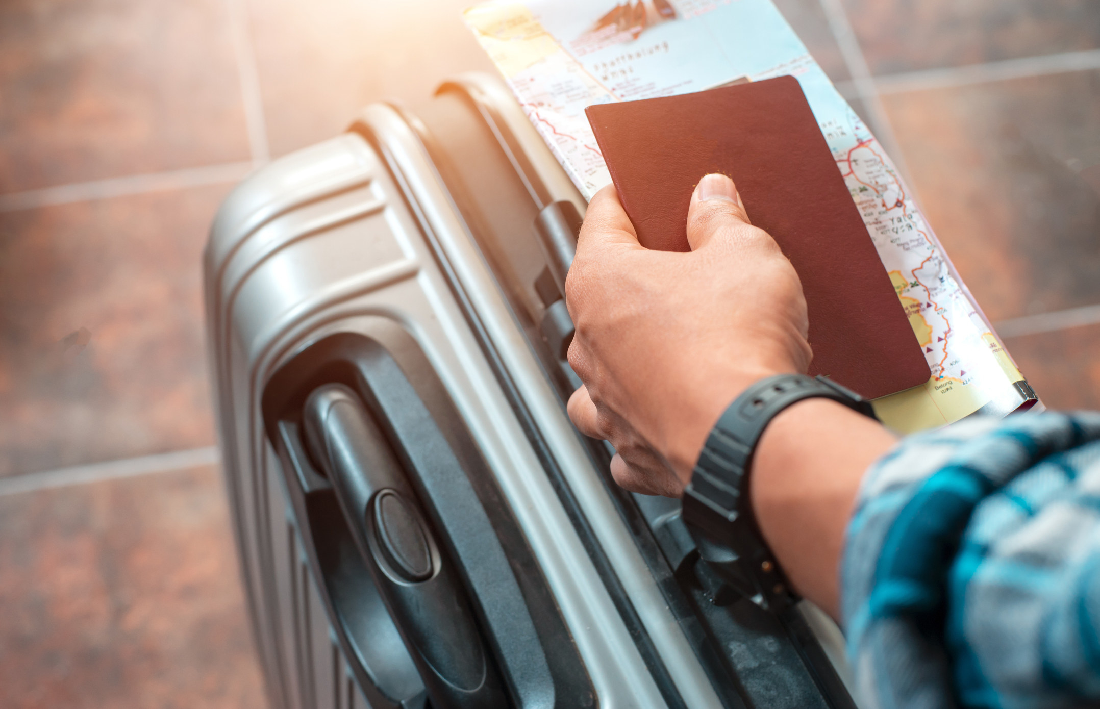 A person with a passport and suitcase.