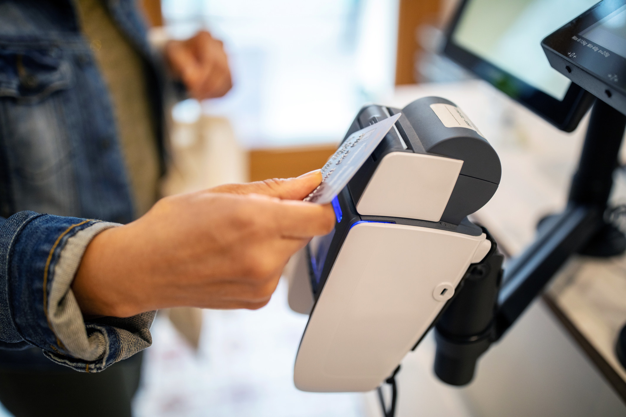 A woman paying with a credit card.