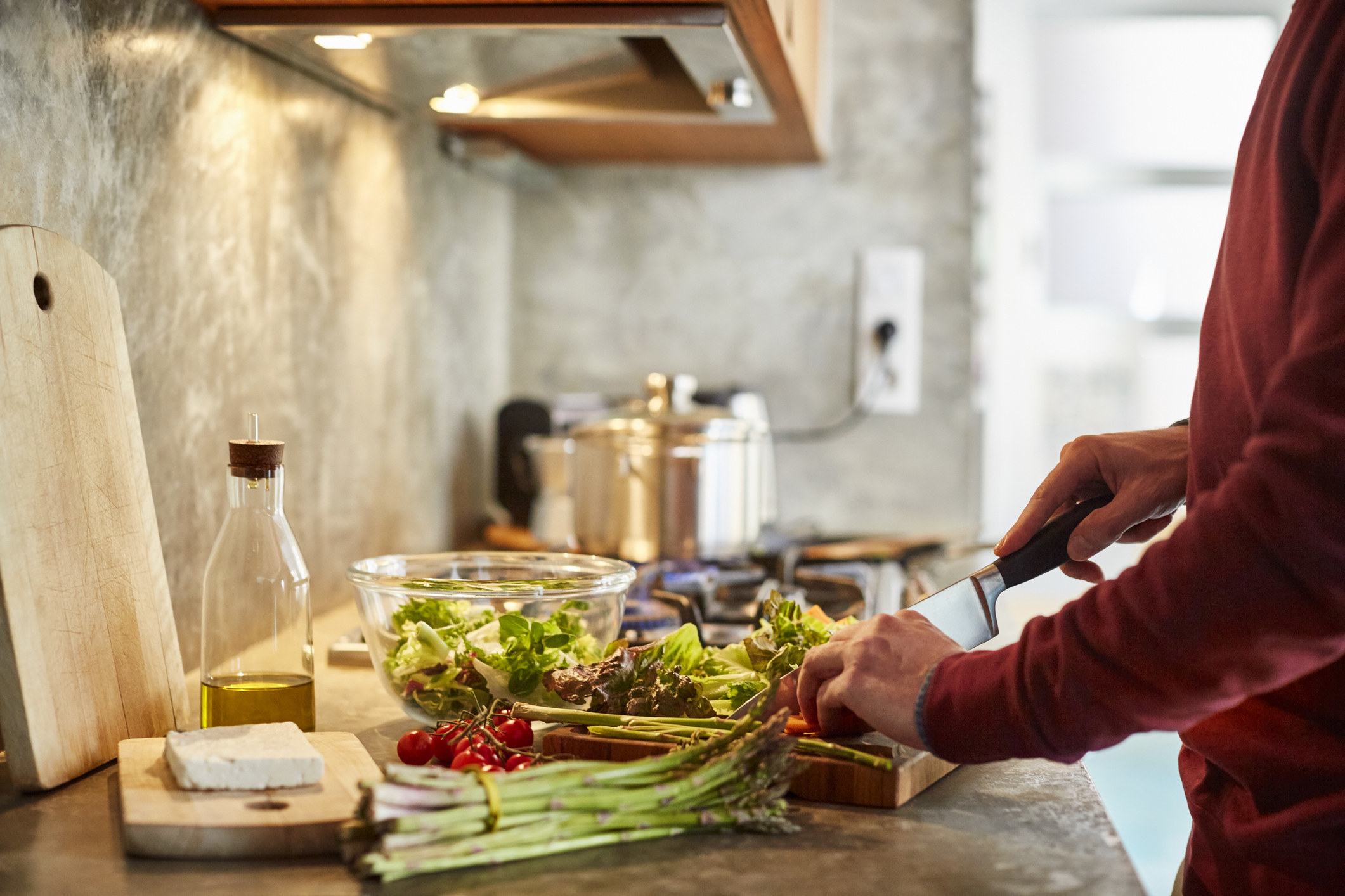 A woman cooking vegetables.