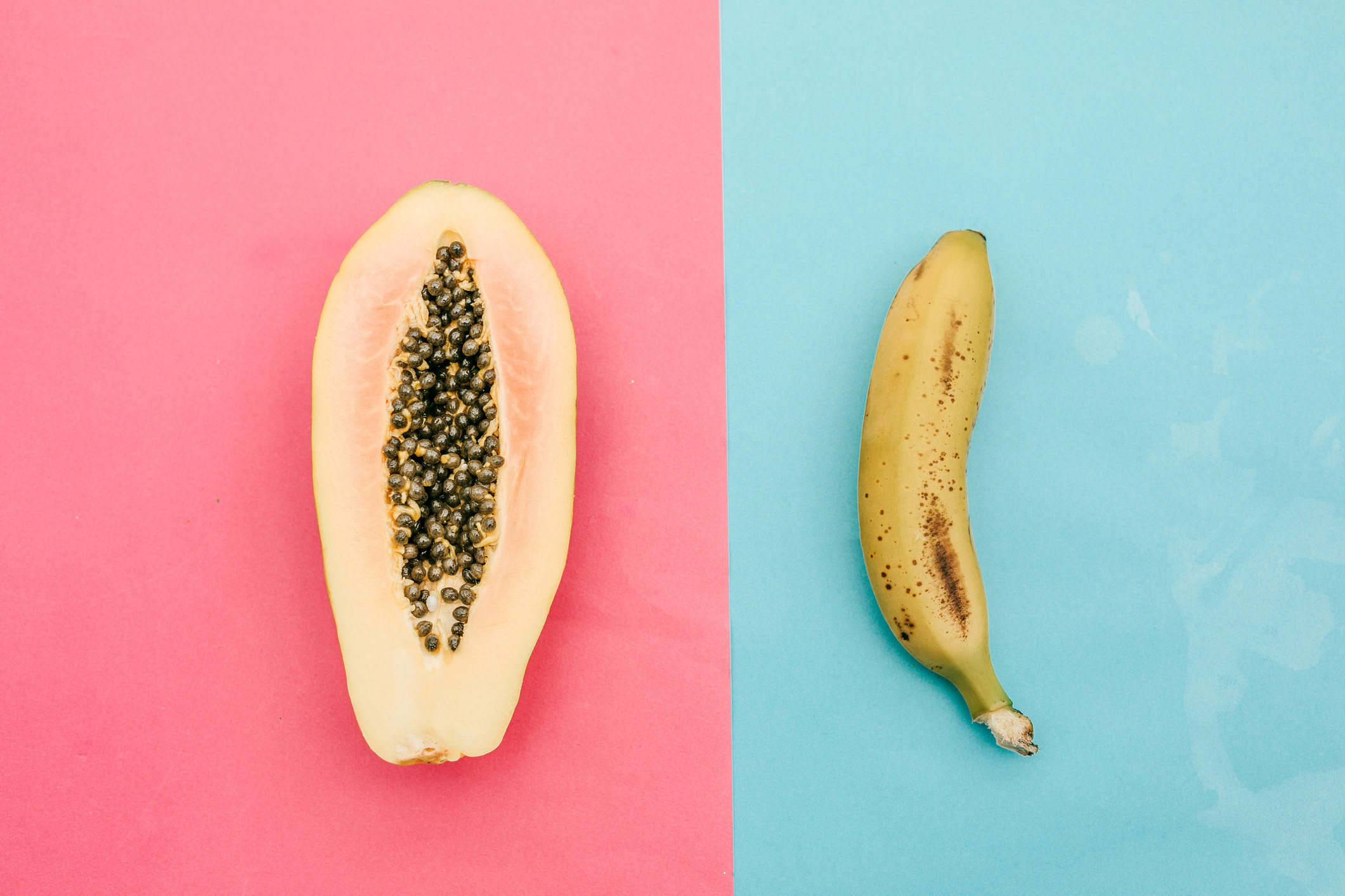 A side-by-side image of a papaya and a banana