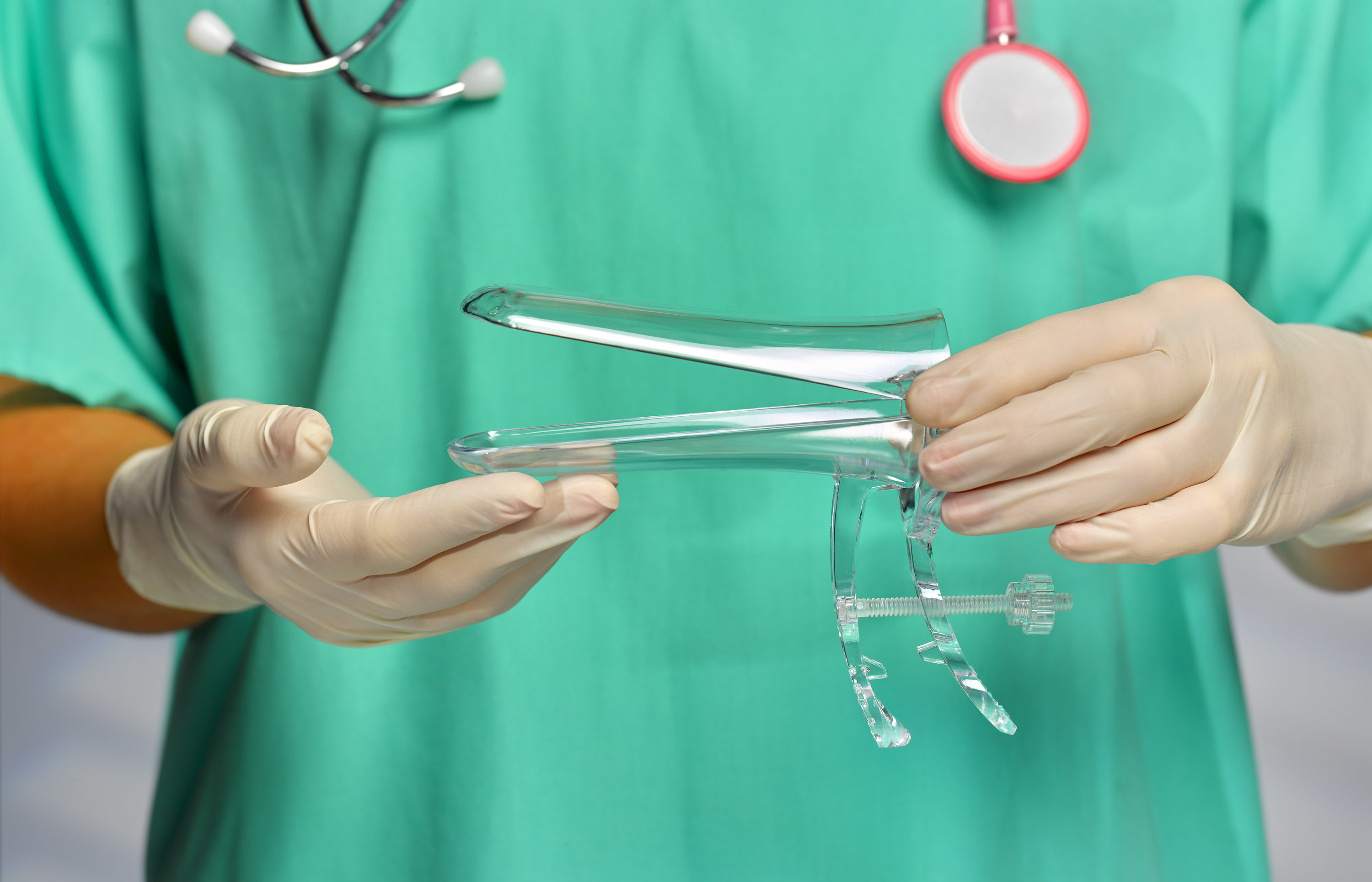 An image of a doctor holding a vaginal speculum