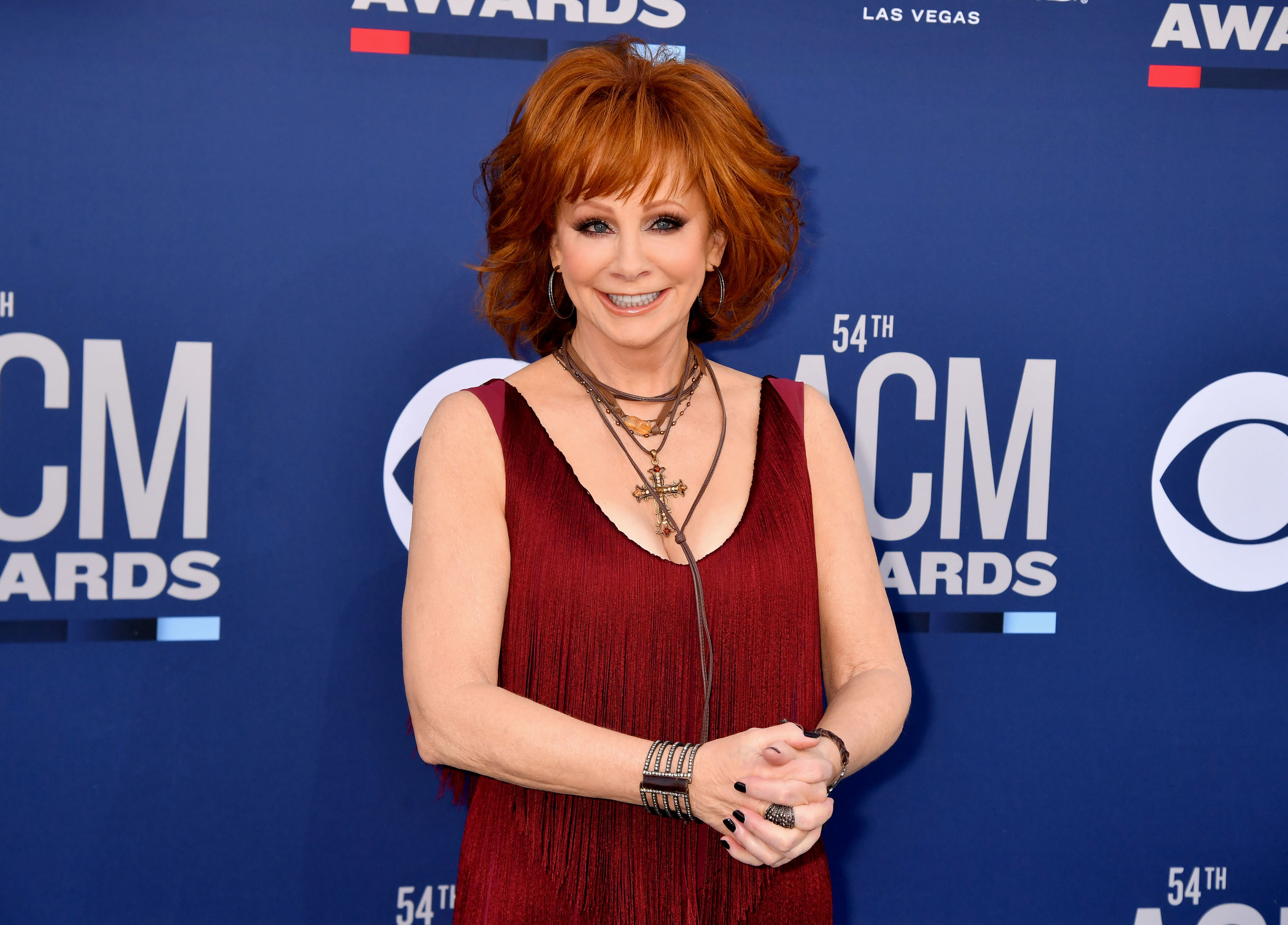 Reba wears a red fringe dress