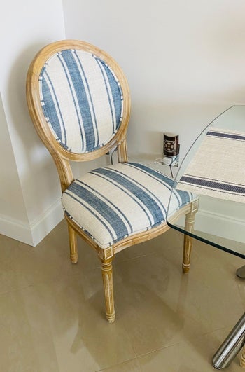 Reviewer's dining chair in a striped blue and white upholstery  
