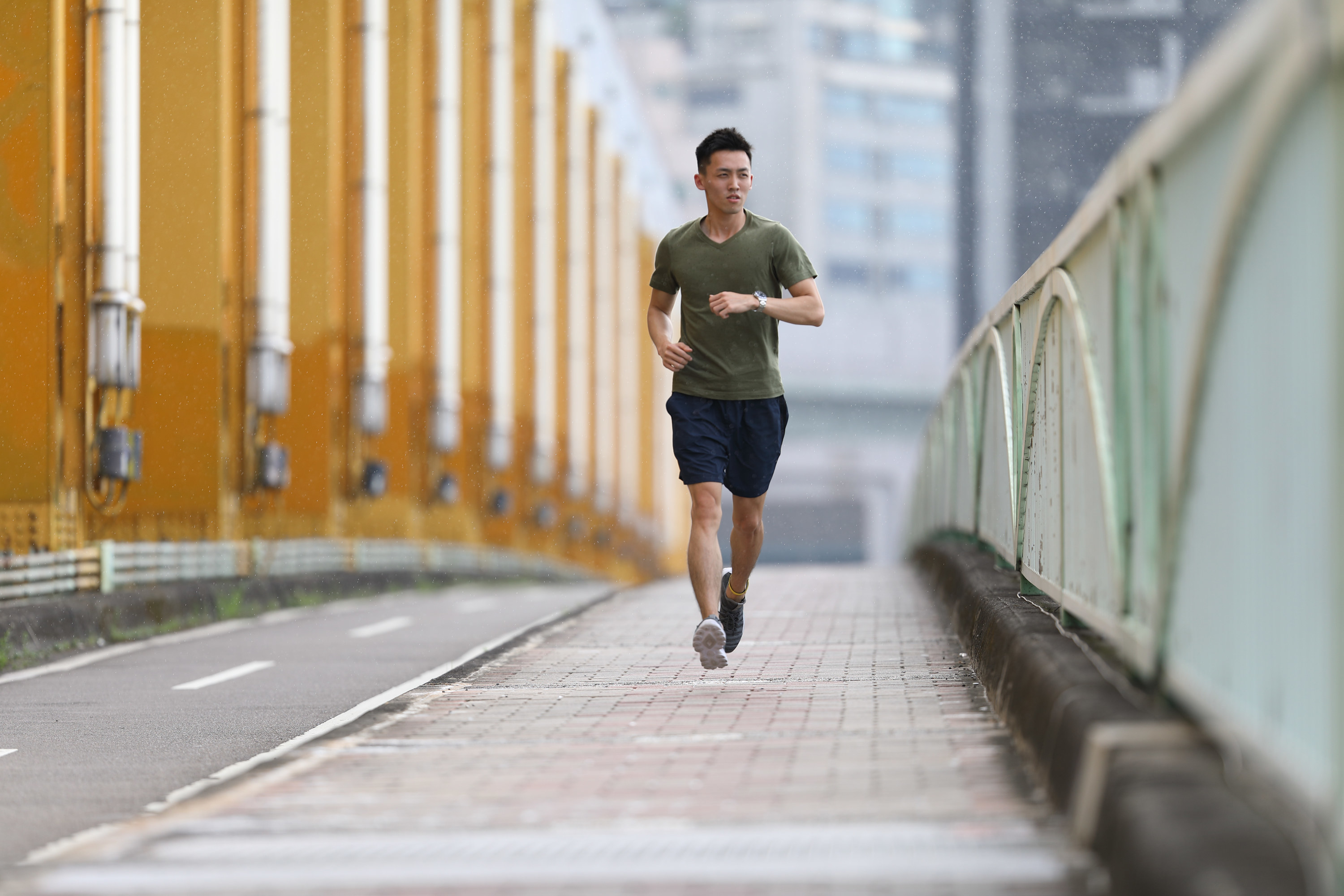 A man jogs across a bridge
