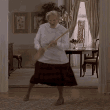 Mrs. Doubtfire using a broom as a guitar