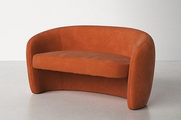 burnt orange organic shaped, curved couch with a floating platform seat