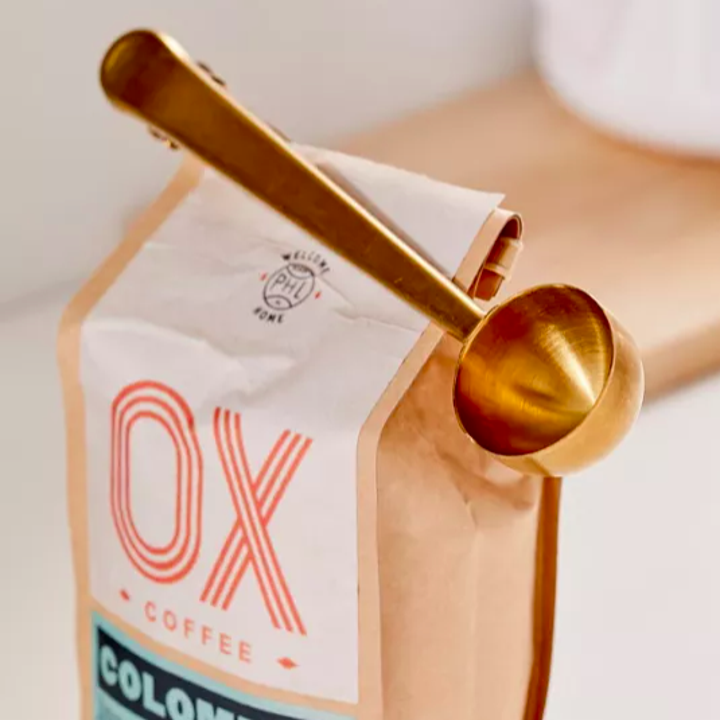 The scoop clip attached to a bag of coffee beans