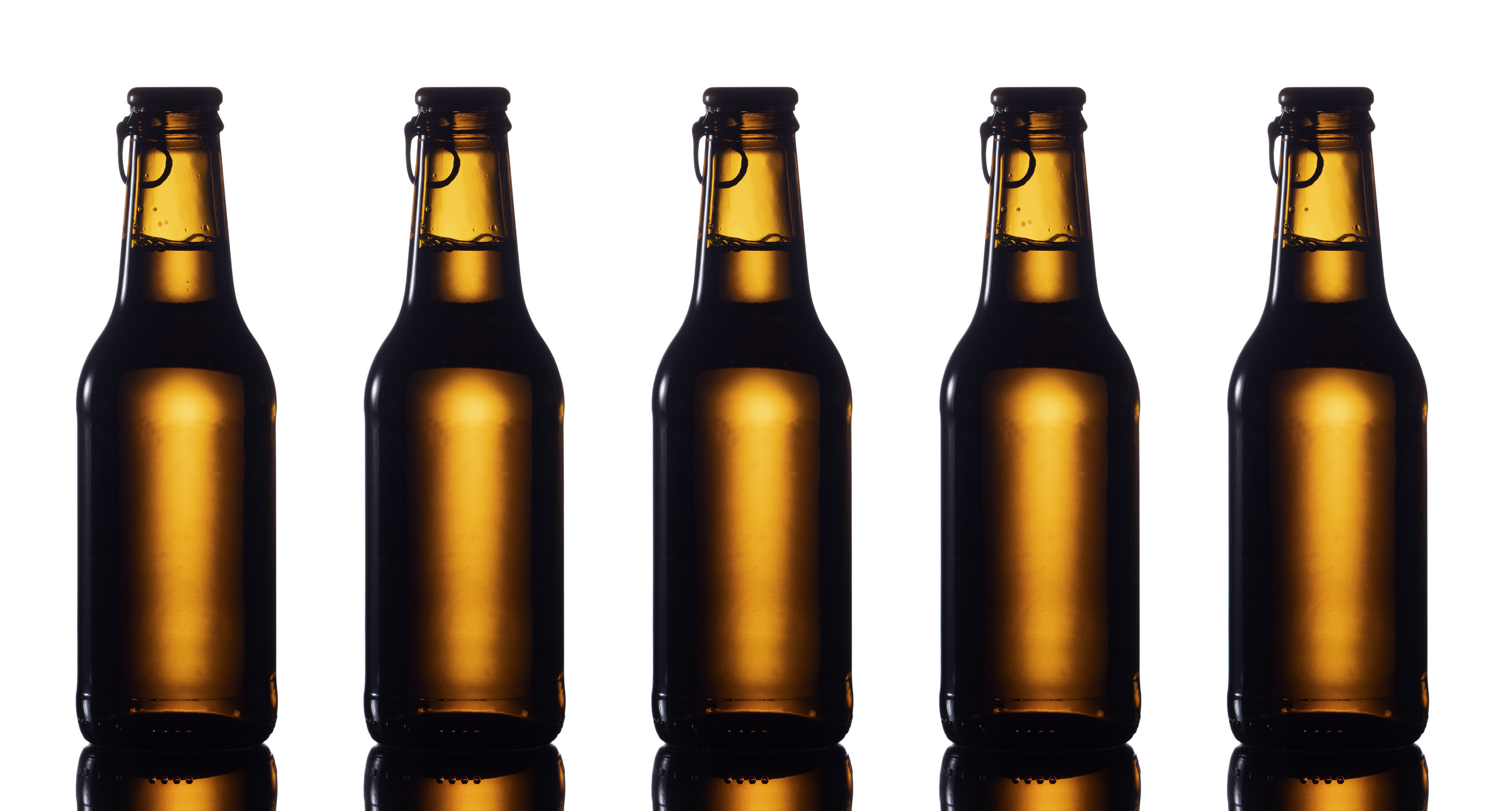 Five label-less beer bottles in a row