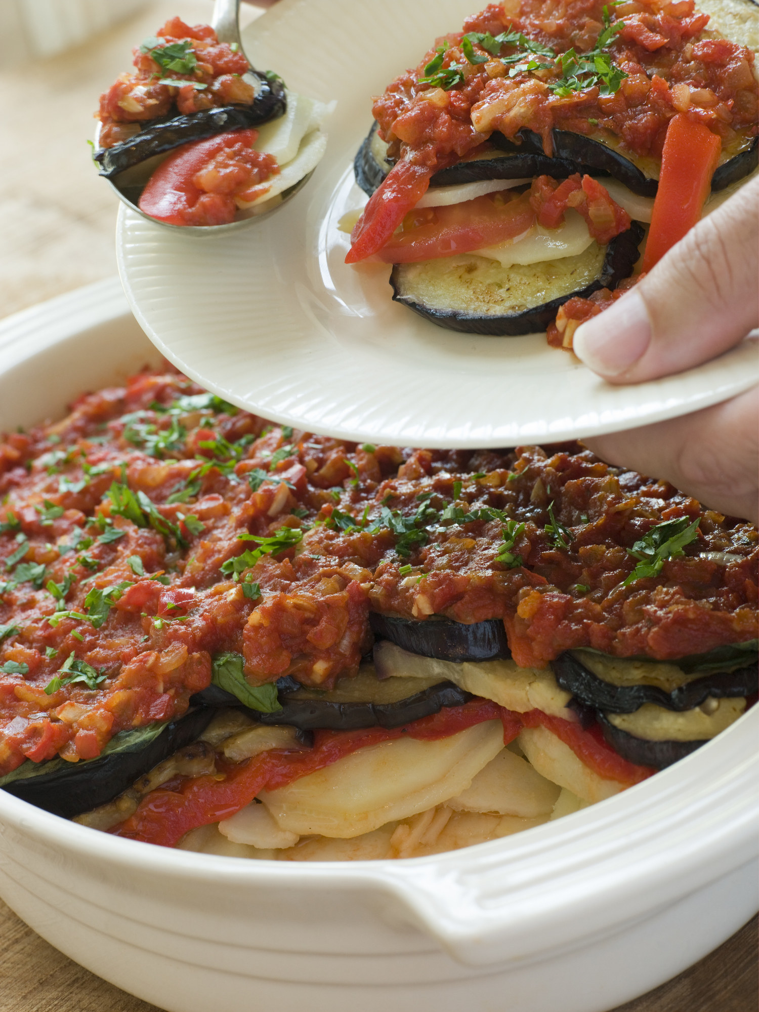 Tumbet aka eggplant layered with potato and tomato sauce.