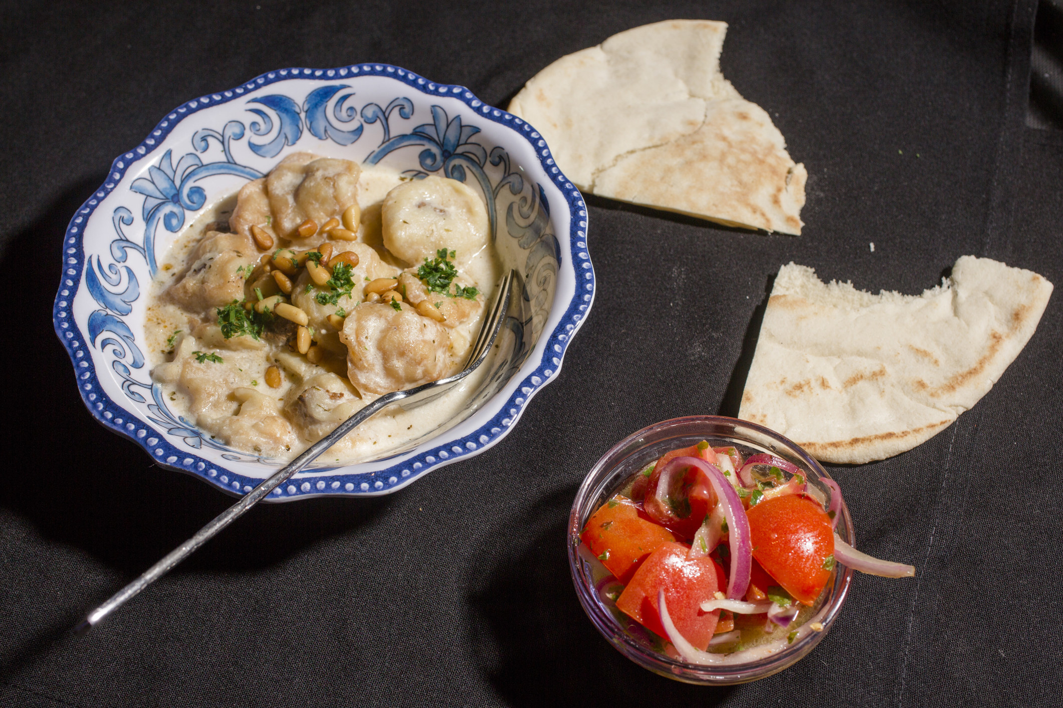 Lebanese shish barak with tomato salad and pita.