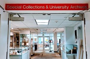 Red background with sliver letters that reads Special Collections and University Archives