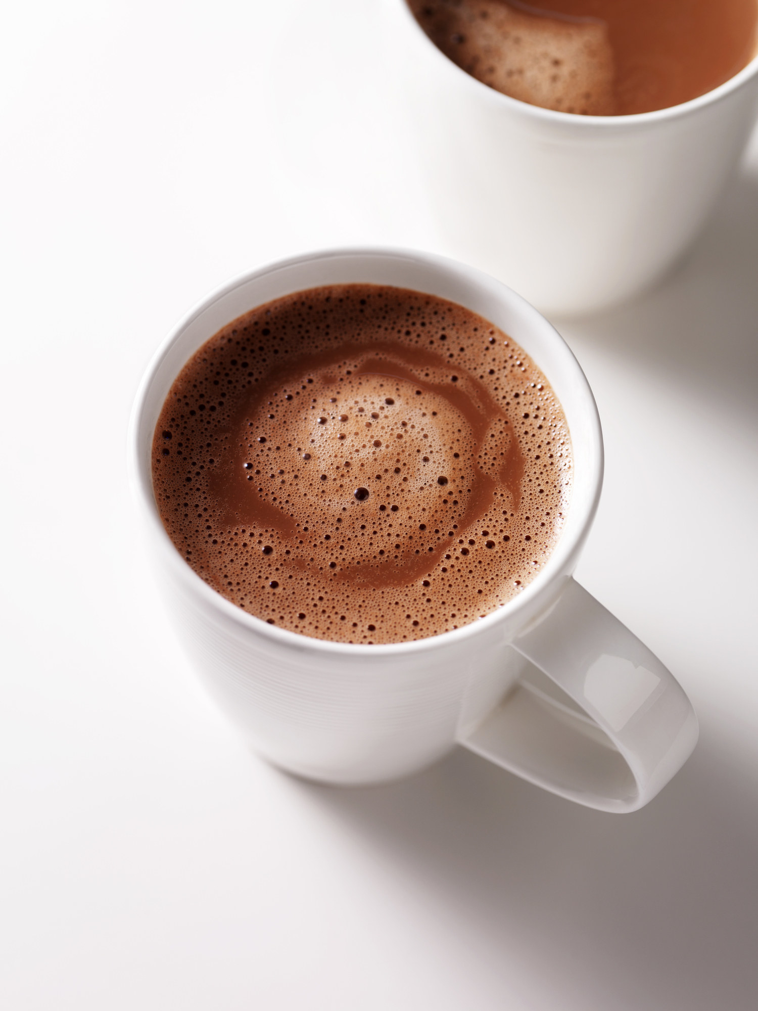 Two mugs of hot chocolate.