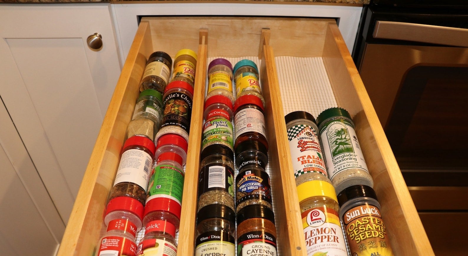 the wooden dividers in a drawer organizing spices