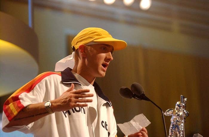 Eminem talking into the mic onstage at the 2002 MTV VMAs