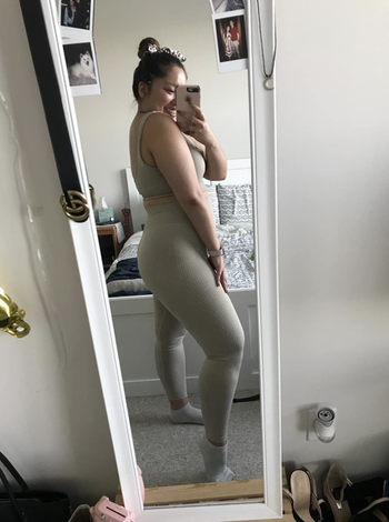 Reviewer in matching gray crop top and leggings