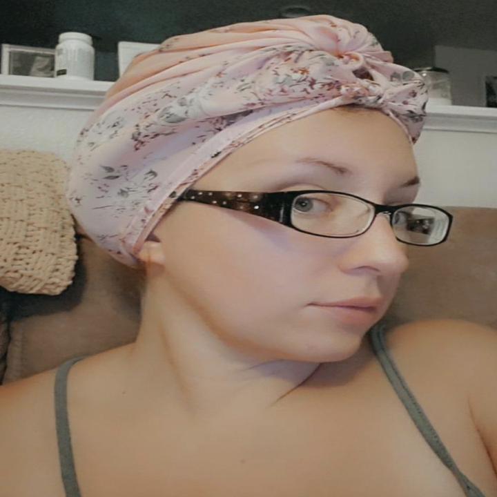 reviewer wearing a pink floral version as a hair wrap 
