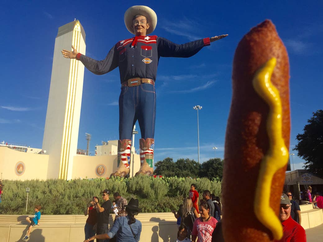 A large statue of a cowboy looks over the fair grounds in Dallas, Texas