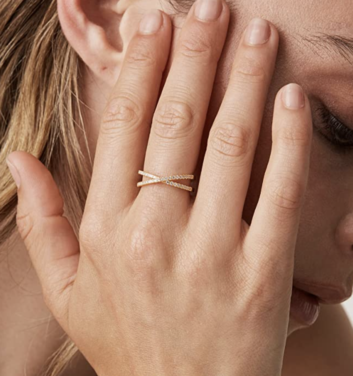 Model wearing faux gold plated diamond criss cross ring