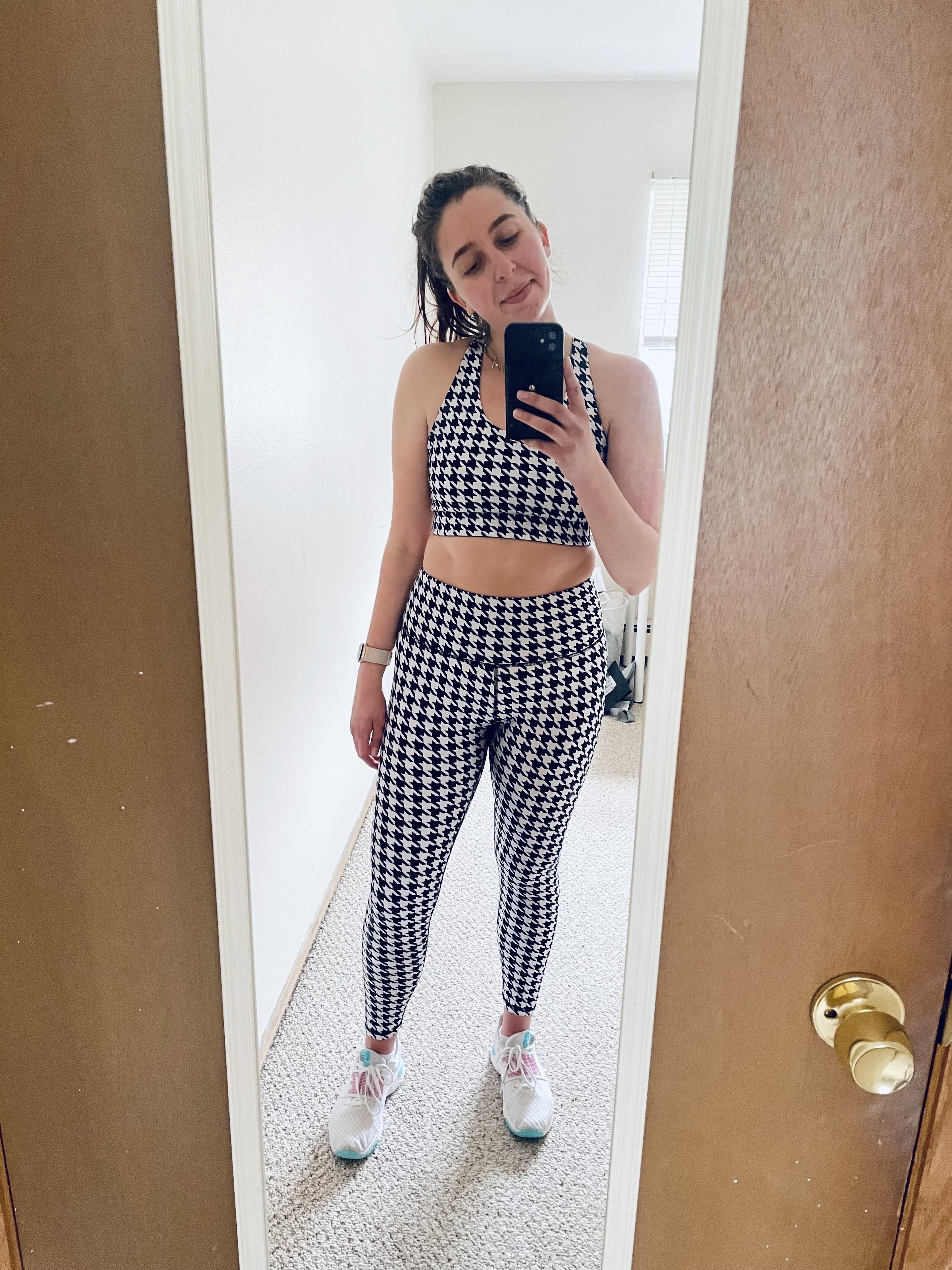 the writer wearing a black and white houndstooth legging and sports bra set